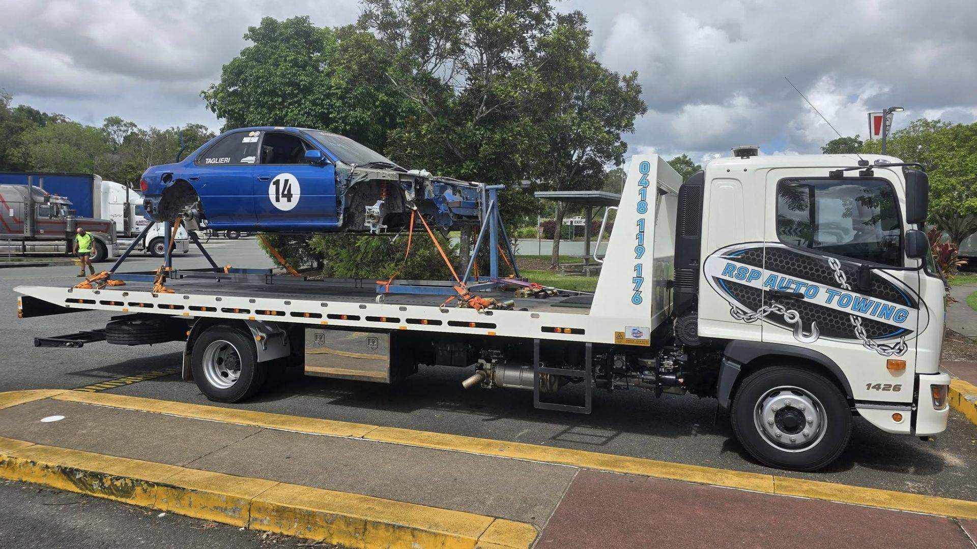 tow truck towing a drag car